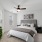 bed with artwork, side tables and plant